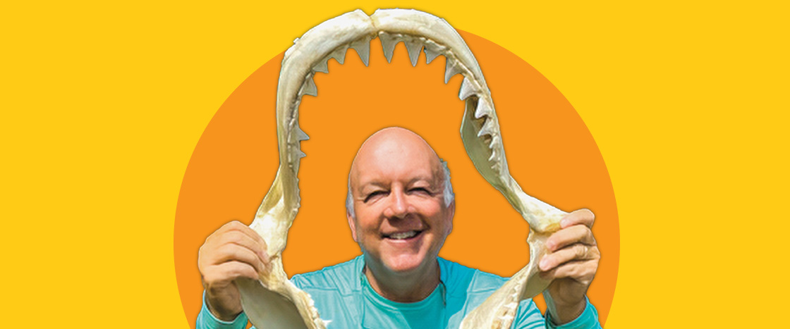 Image of an author holding a shark's jaw